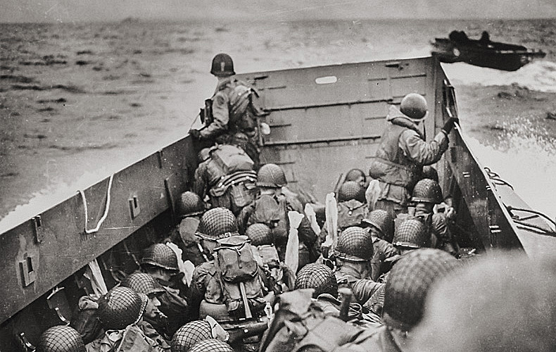 American troops crouch inside a landing craft headed toward Omaha Beach.