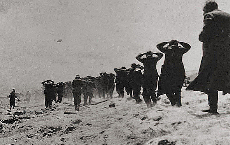 The first of Hitler's troops overtaken by Americans, trudge along to become prisoners of war.