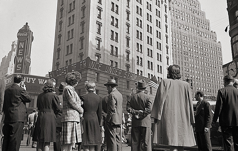 A crowd in Times Square, New York, watches the electronic news ticker on the New York Times building for any updates concerning the D-Day invasion.