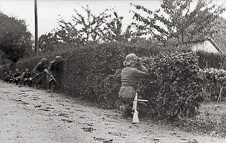 German infantry crouch behind hedges ready for an ambush. Much of the combat off the beaches involved small unit clashes.