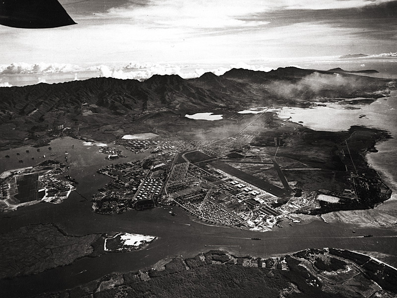 Aerial photo of the vast U.S. Naval Base at Pearl Harbor, Hawaii, looking eastward, October 1941. Ford Island is seen on the left.