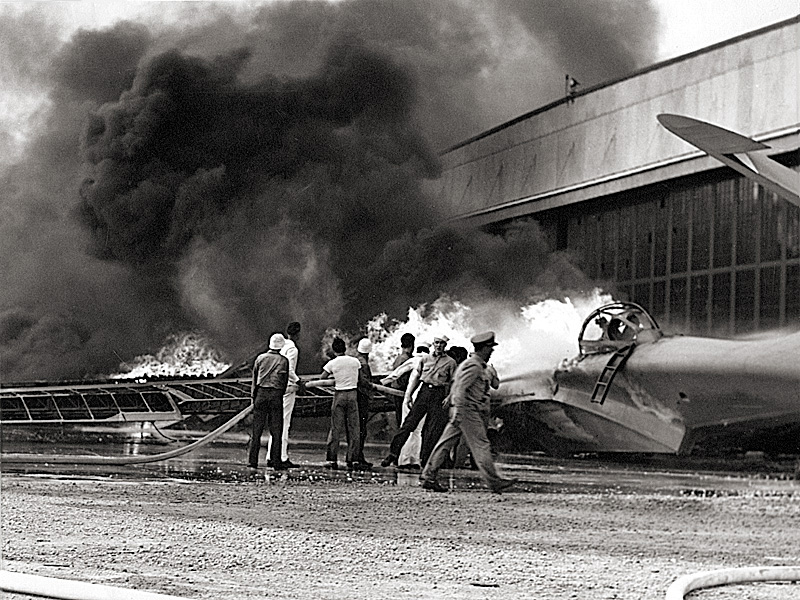 A PBY patrol bomber burns at the Naval Air Station in nearby Kaneohe Bay.