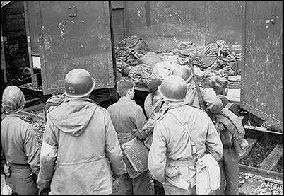 At Dachau Concentration Camp, ex-Hitler Youths are escorted by Americans to view train cars filled with bodies of prisoners who died from starvation and disease on the trip from outlying concentration camps in the war's final days.