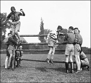 HJ boys navigate an obstacle course under the guidance of their leaders. 