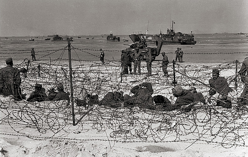 German prisoners are held in a barbed-wire enclosure on Utah Beach.