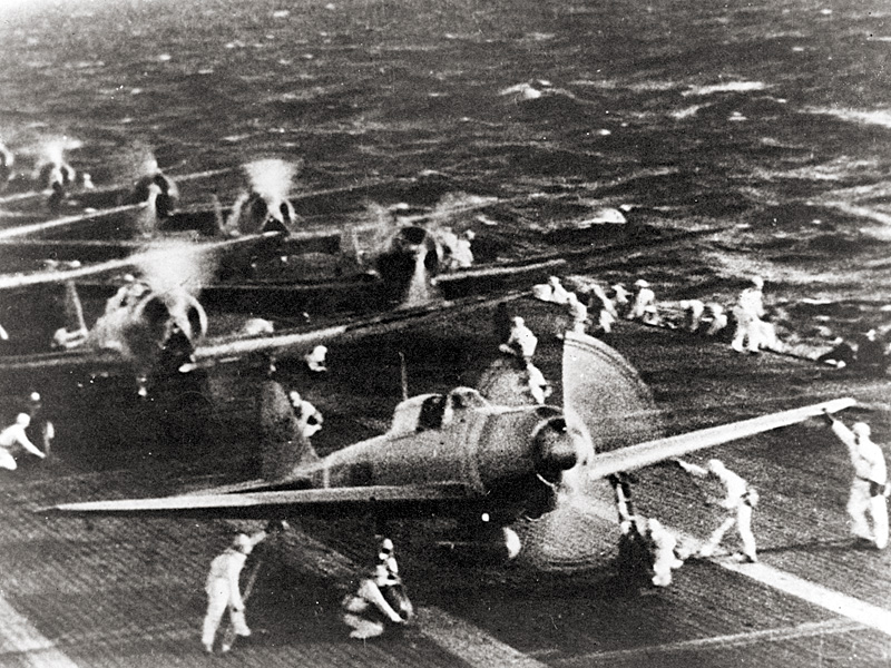 Japanese Naval aircraft prepare to take off from an aircraft carrier (reportedly Shokaku) to attack Pearl Harbor on the morning of December 7th, 1941. Plane in the foreground is a Zero Fighter.