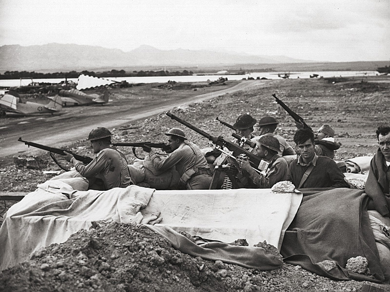 Marines and soldiers fire on raiding Japanese planes.