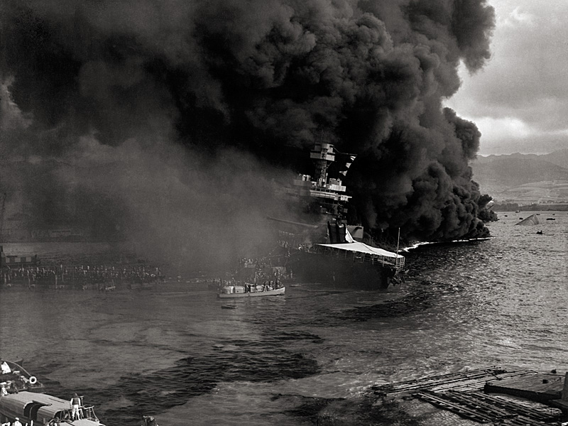 Crewmen abandon the damaged USS California as burning oil drifts toward the ship.
