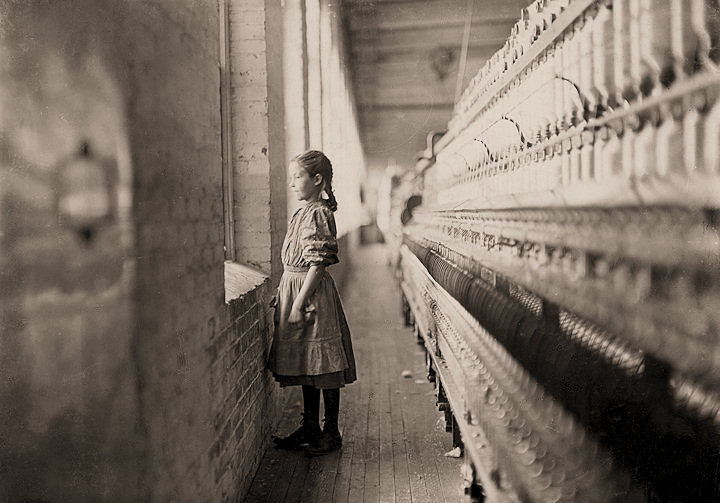 Lewis Hine's photo of a young girl looking out a factory window