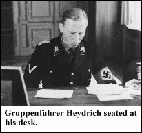 Heydrich seated at his desk