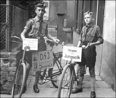 Hitler Youths on bicycles with publicity signs saying "Are you a German boy?" and "Come into our Jungvolk!"