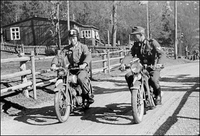 An instructor (right) critiques a student rider training for the Motor-HJ.