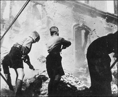 On the German home front, HJ boys clean up the rubble after yet another air-raid.